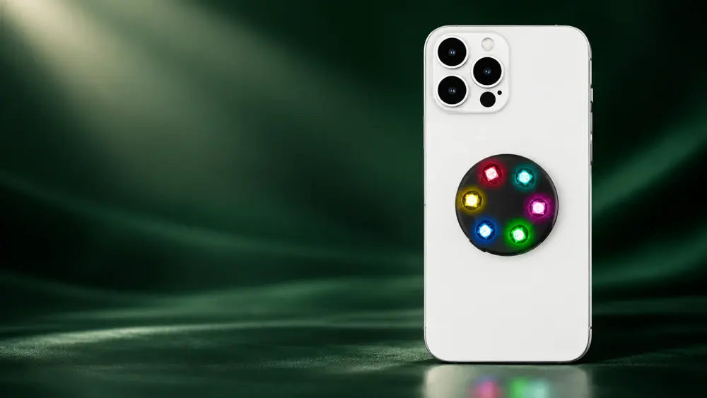 Brightgrip multicolor LED phone grip on a white phone in an emerald studio setting