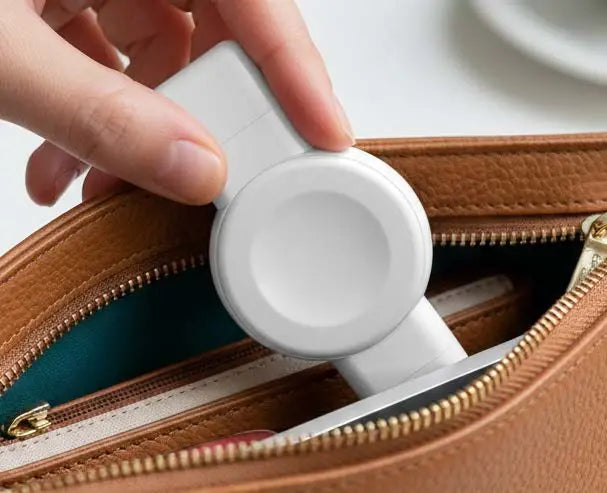White plug-in watch charger tucked into a bag